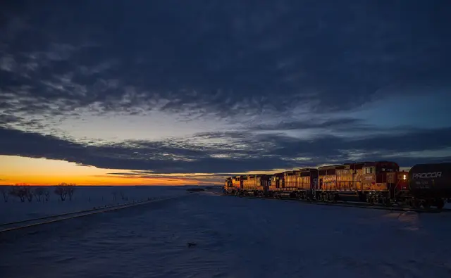 CP locomotives at dusk on the snowy prairie near Wilkie